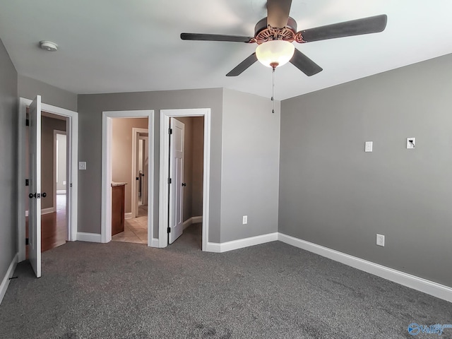 unfurnished bedroom featuring ensuite bath, ceiling fan, and carpet