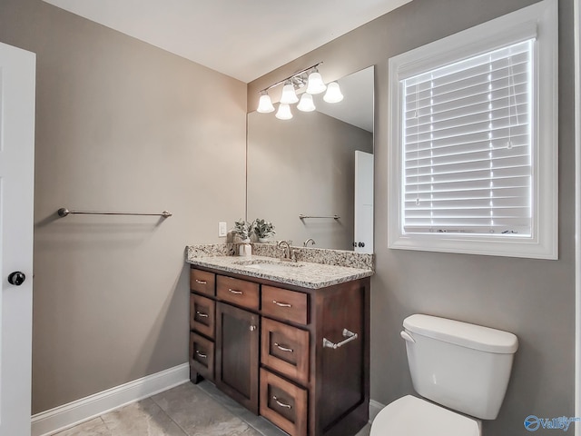 bathroom with vanity, tile patterned flooring, and toilet