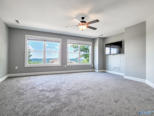 unfurnished living room with carpet flooring and ceiling fan