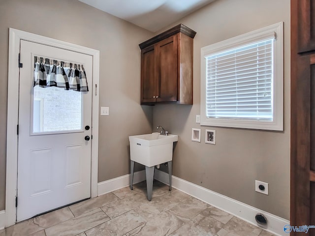 washroom with hookup for a washing machine, cabinets, and hookup for an electric dryer