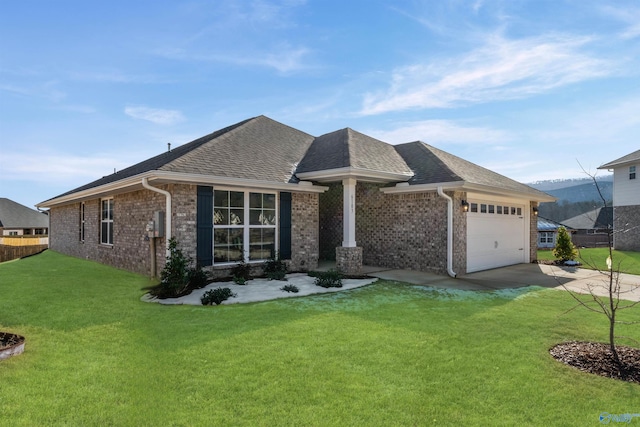 view of front of home with driveway, a front lawn, an attached garage, and brick siding