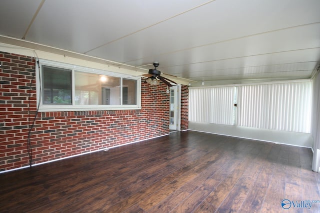 unfurnished sunroom with ceiling fan