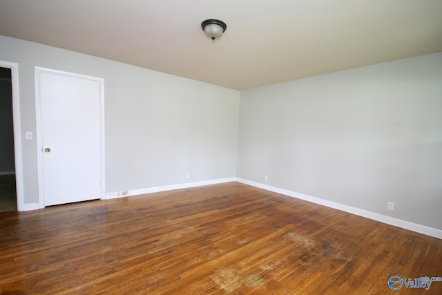 empty room with dark wood-type flooring