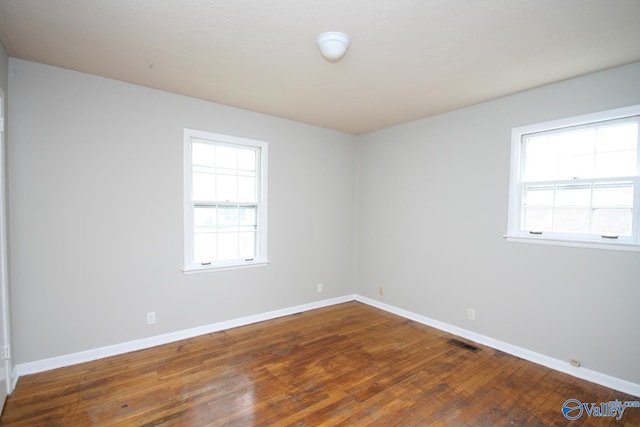 spare room featuring dark hardwood / wood-style flooring