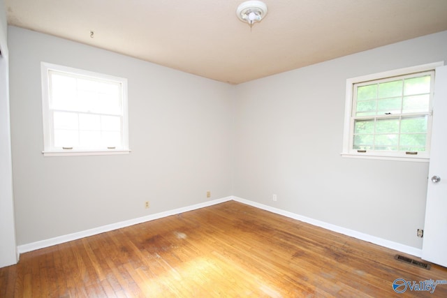 spare room with wood-type flooring