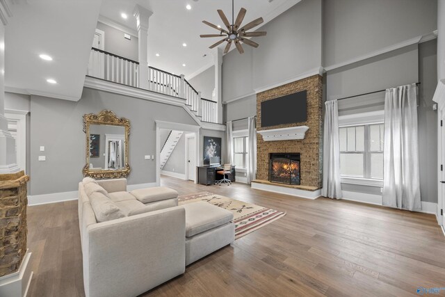 2603 Whitesburg Dr, Huntsville, AL 35801 - living area featuring ceiling fan, a high ceiling, stairs, and a fireplace