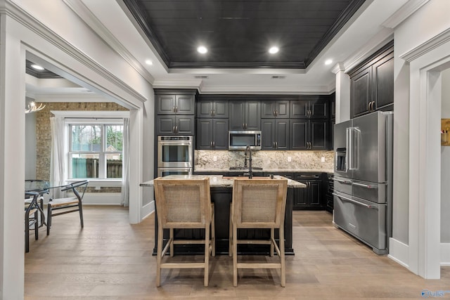 2603 Whitesburg Dr, Huntsville, AL 35801 - kitchen featuring light stone counters, light wood finished floors, appliances with stainless steel finishes, and ornamental molding