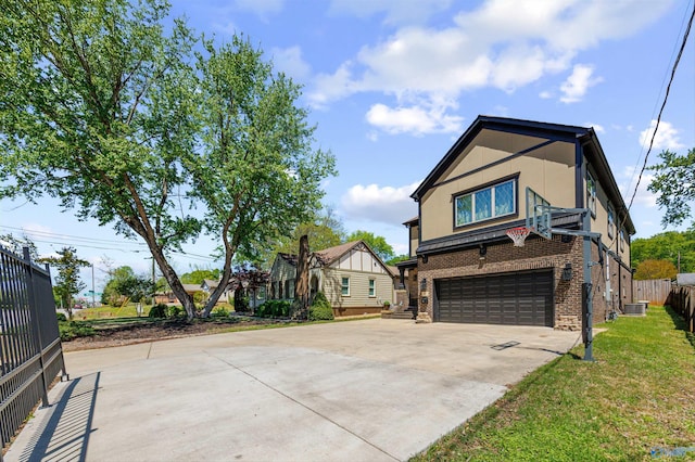 2603 Whitesburg Dr, Huntsville, AL 35801 - exterior space featuring a front lawn, driveway, fence, brick siding, and an attached garage