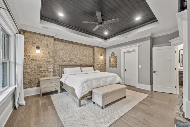 2603 Whitesburg Dr, Huntsville, AL 35801 - bedroom featuring a tray ceiling, light wood-type flooring, baseboards, ceiling fan, and crown molding