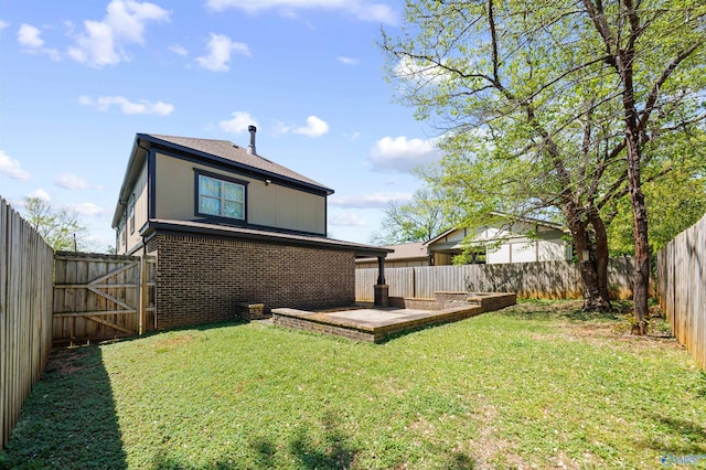 2603 Whitesburg Dr, Huntsville, AL 35801 - back of house featuring brick siding, a lawn, a patio, and a fenced backyard