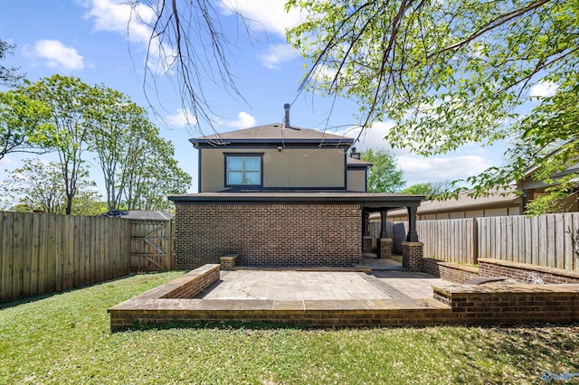2603 Whitesburg Dr, Huntsville, AL 35801 - rear view of house featuring a gate, a patio area, a fenced backyard, a yard, and brick siding