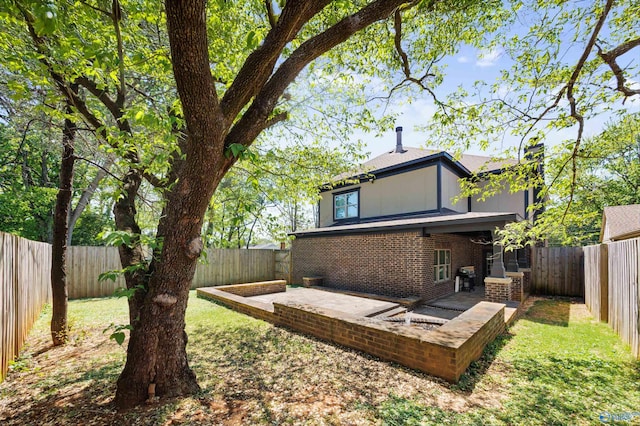2603 Whitesburg Dr, Huntsville, AL 35801 - rear view of property featuring a fenced backyard, brick siding, and a patio area
