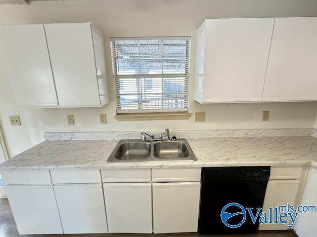 kitchen featuring dishwasher, white cabinets, light stone countertops, and sink