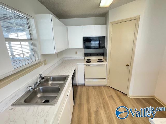 kitchen with light wood-type flooring, a textured ceiling, sink, black appliances, and white cabinetry