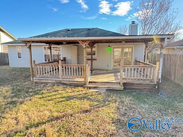 back of house featuring french doors, a yard, and a wooden deck