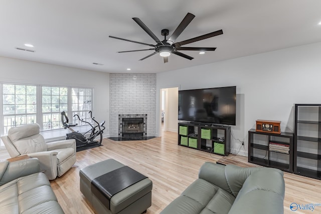 living room with ceiling fan and light hardwood / wood-style floors