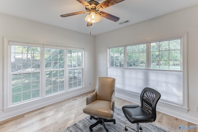 sitting room featuring ceiling fan, light hardwood / wood-style flooring, and a wealth of natural light