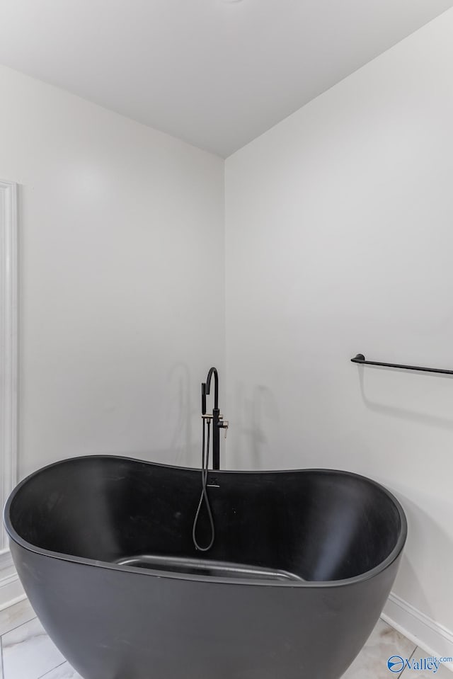 interior details with sink, a bath, and tile patterned floors