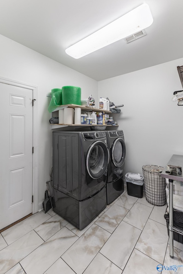 clothes washing area with independent washer and dryer