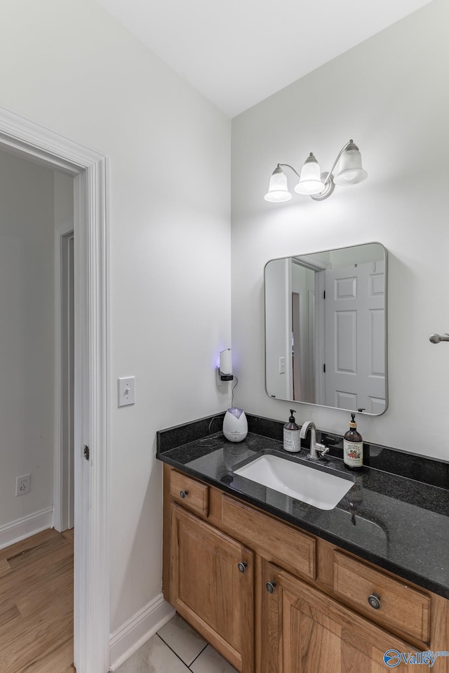 bathroom with vanity and hardwood / wood-style floors