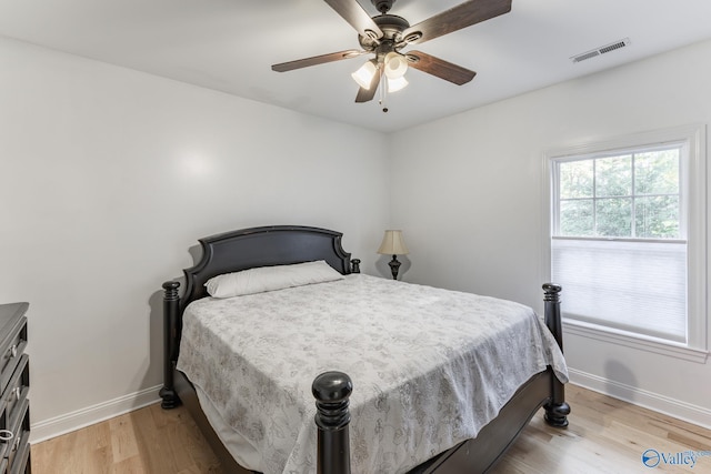 bedroom with light wood-type flooring and ceiling fan