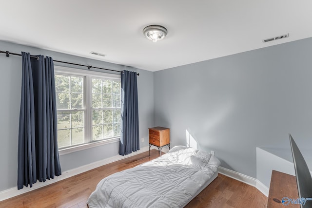 bedroom with hardwood / wood-style flooring