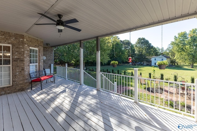 deck with ceiling fan and a lawn