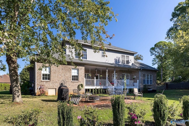 back of property featuring a yard and a porch