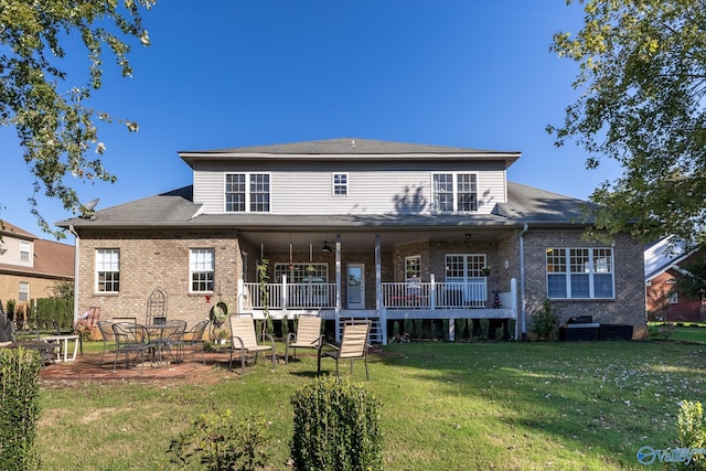 rear view of house featuring a yard