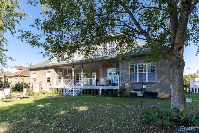 back of property with a yard and a deck