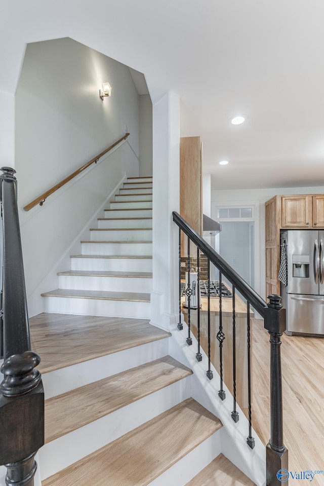 stairs with hardwood / wood-style flooring