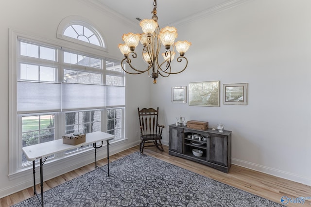 office space featuring wood-type flooring, ornamental molding, and a wealth of natural light