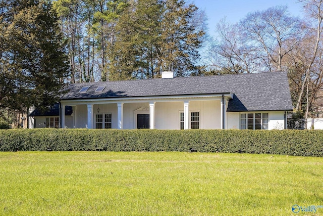 ranch-style home featuring a front lawn, a chimney, and a shingled roof