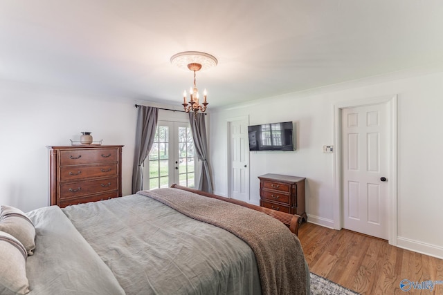 bedroom with a chandelier, baseboards, light wood-style floors, access to outside, and french doors