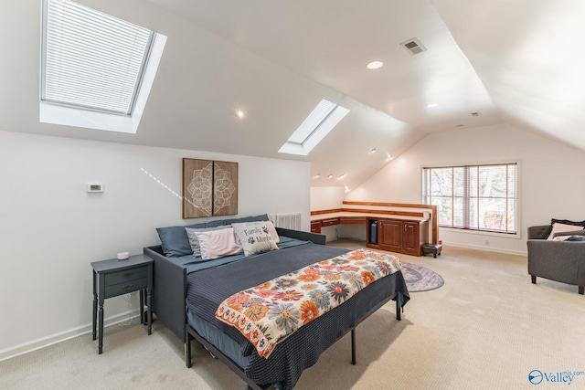 bedroom with light carpet, vaulted ceiling with skylight, visible vents, and baseboards