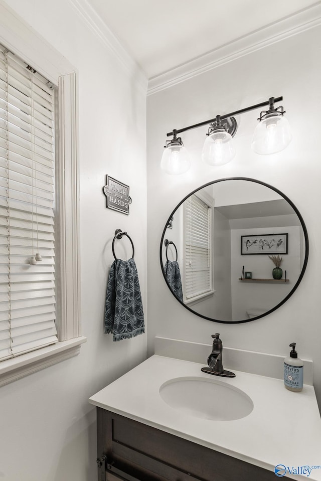 bathroom with ornamental molding and vanity