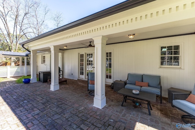 view of patio / terrace with an outdoor hangout area, fence, and a ceiling fan