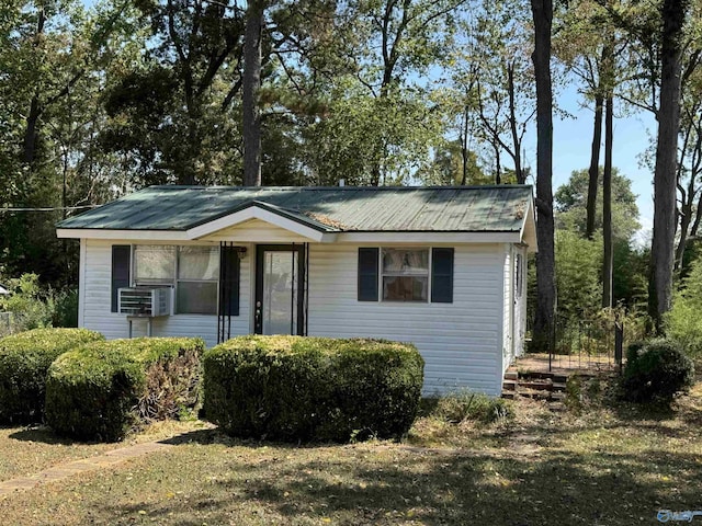 view of front of house with metal roof and cooling unit