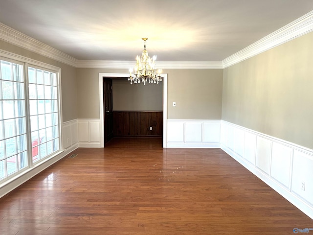 unfurnished dining area with visible vents, a chandelier, dark wood finished floors, and crown molding