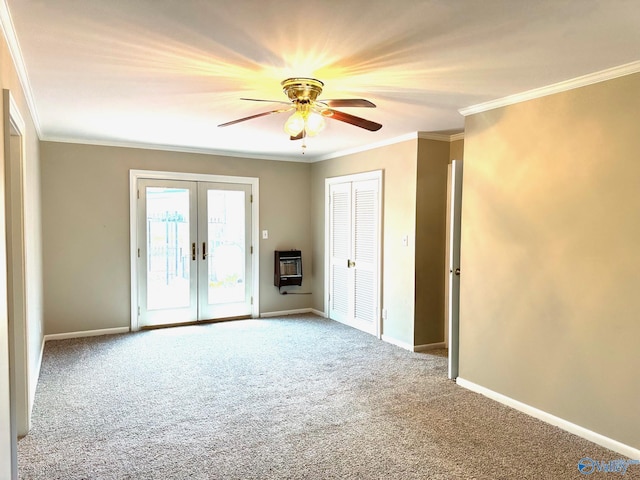 carpeted empty room featuring french doors, crown molding, heating unit, a ceiling fan, and baseboards