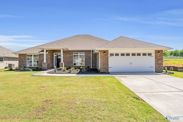 view of front of house with a garage, central AC, and a front yard