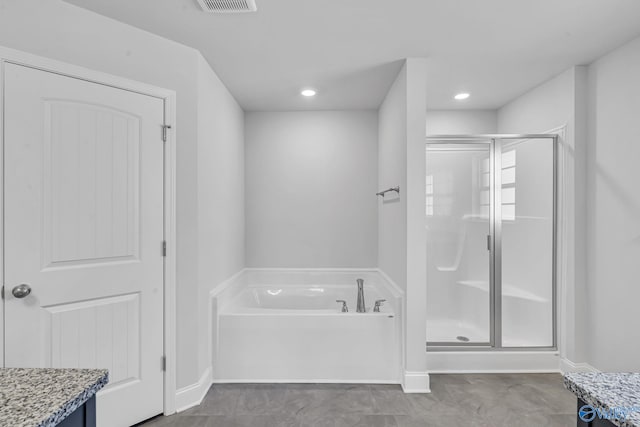 full bath featuring vanity, baseboards, visible vents, a shower stall, and a bath