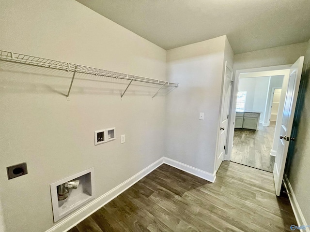 laundry room featuring electric dryer hookup, wood finished floors, hookup for a washing machine, and laundry area