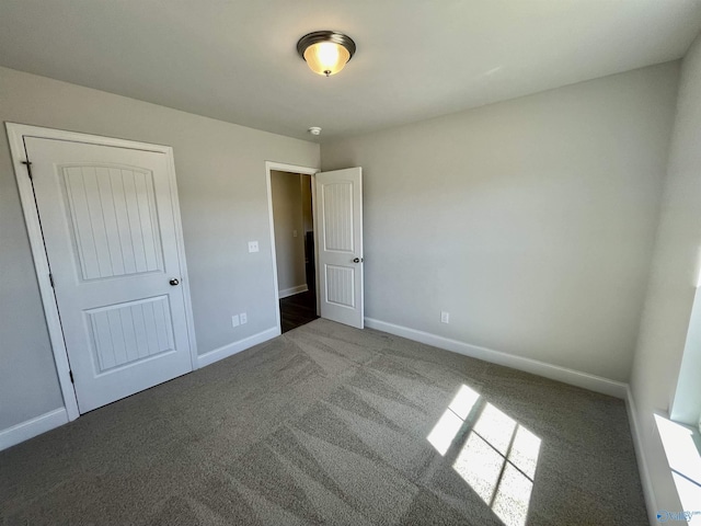 unfurnished bedroom featuring baseboards and carpet flooring