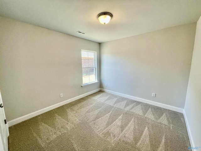 unfurnished room featuring carpet flooring, baseboards, and visible vents