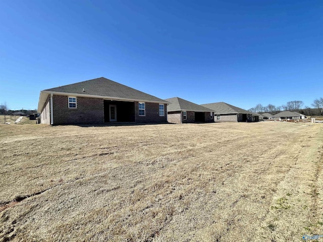 rear view of property with brick siding