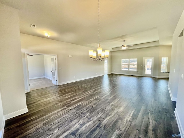 interior space with dark wood-type flooring, ceiling fan with notable chandelier, baseboards, and visible vents