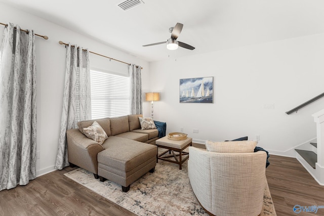 living room featuring hardwood / wood-style flooring and ceiling fan