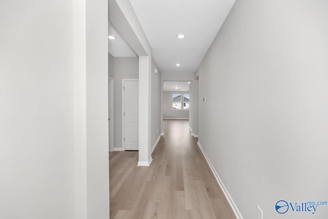 corridor with light hardwood / wood-style flooring