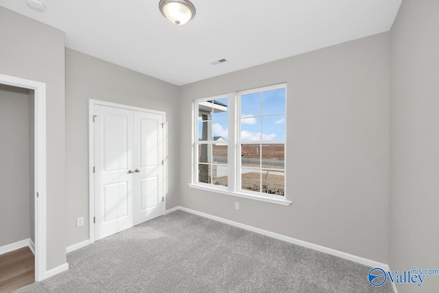 unfurnished bedroom featuring carpet floors and a closet